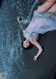 A woman laying on a beach next to the ocean.