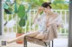 A woman sitting on a chair with her legs crossed.